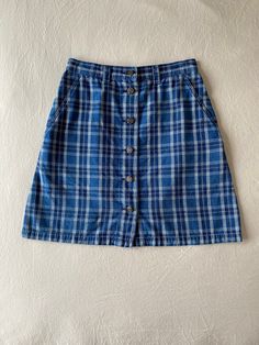 Details:  90s, liz wear, blue plaid button down mini skirt Condition:  Item is in excellent condition with no noted flaws *(this skirt has been washed and sanitized) Measurements: (all measurements taken flat in inches, then doubled where appropriate) Waist: 28 Hip: 36 Length: 19 Label Size: 10 (this would fit more like a modern-day size 6) Fabric Content:  100% cotton Care Instructions: Machine wash cold with like colors, tumble dry low heat or hang dry Return Policy: I do not accept returns, h Casual Plaid Cotton Mini Skirt, Plaid Cotton Mini Skirt Skort, Plaid Cotton Mini Skort, Plaid Cotton Skirt For School, School Plaid Cotton Skirt, Cotton Plaid Skirt For School, Blue Retro Mini Skirt With Pockets, Retro Blue Mini Skirt With Pockets, Blue Button-up Cotton Skirt