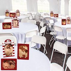 there are many pictures on the tables in this photobooting booth that is decorated with white chairs and black polka dot tablecloths