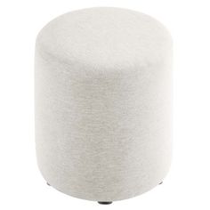 a white round ottoman sitting on top of a wooden table