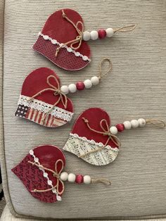 three red heart shaped ornaments on a chair