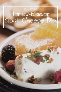 honey - bacon goat cheese dip on a white plate with berries and other food items