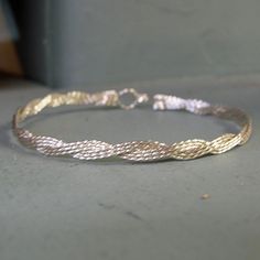 Six sterling silver wires, twisted then braided together for a sensuous, slinky look. Fun, unique, and stackable with so many of my other bracelet designs! The built-in hook and eye clasp is easy to get on and off yourself. What a great gift! So affordable, for a birthday, anniversary, or Christmas. Or as a sweet treat for yourself! Choose your size from the variations listed for the most comfortable fit. Also available in 14kt gold filled wire, or in two-tone. Add on a jewelry polishing cloth a Adjustable Jewelry With Interwoven Design For Gifts, Adjustable Interwoven Bracelets As Gift, Braided Metal Bracelets As Gift, Adjustable Silver Bangle With A Modern Twist, Adjustable Braided Sterling Silver Bracelet, Elegant Bracelets With Interwoven Design As Gift, Elegant Bracelets With Interwoven Design For Gift, Elegant Adjustable Braided Jewelry, Adjustable Twisted Silver Bracelets