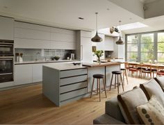 an open kitchen and living room with wood flooring