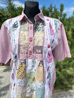 a pink shirt with patchwork and flowers on it