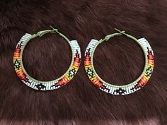 Authentic Beautiful Native American Indian Jewelry Navajo Zuni Hand Beaded 2.25 inch Hoop Earrings Great for a  Gift❤️ Handcrafted by Navajo Artist H. Crosby  Present in virtually every Native American tribe, the feather symbol is universally recognized as a representation of trust, strength, wisdom, freedom, and honor. Incorporated into many sacred pieces of Native American wear, the feather is easily one of the most respected symbols. Native American Hoop Earrings, Southwestern Beaded Round Earrings, Southwestern Style Beaded Round Earrings, Southwestern Round Beaded Earrings, Southwestern Style Festival Earrings, Southwestern Style Round Festival Earrings, Southwestern Style Festival Round Earrings, Southwestern Adjustable Hoop Jewelry, Traditional Small Hoop Beaded Jewelry