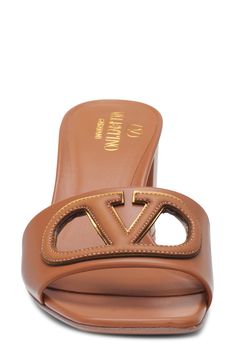 An iconic VLOGO stands out even further with crisp cutouts on an Italian-leather slide sandal set on a chunky block heel. 2 3/4" (70mm) heel (size 38.5) Leather upper, lining and sole Made in Italy Designer Shoes Luxury Slides With Padded Heel, Luxury Brown Slides, Luxury Slides With Leather Sole And Open Heel, Luxury Leather Sole Slides With Open Heel, Luxury Slides With Branded Insole And Open Heel, Designer Brown Mules With Padded Heel, Luxury Summer Sandals With Logo, Chic Open Toe Sandals With Logo, Designer Brown Slides