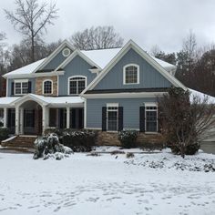 a blue house with snow on the ground