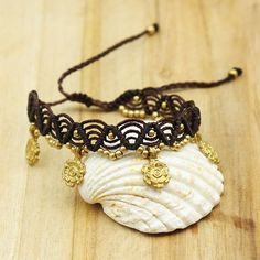 This fancy anklet is in dark brown macramé with small golden brass plates. Its size is adjustable on the ankle thanks to its sliding knot. This anklet can go in water because the brass does not move. You will wear this foot chain on an ethnic, boho or hippie chic outfit. foot chain width 2.5cm Gold Adjustable Friendship Bracelets For Festivals, Gold Friendship Bracelets With Sliding Knot For Festivals, Adjustable Gold Friendship Bracelets For Festivals, Adjustable Gold Friendship Bracelet For Festivals, Beach Jewelry With Brown Tassels, Bohemian Gold Bracelet With Adjustable Length, Gold Adjustable Cord Friendship Bracelets For Beach, Gold Friendship Bracelets With Adjustable Cord For Beach, Brown Macrame Friendship Bracelets For Festival