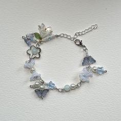 The blue lily bracelet is a handmade unique design which will make whoever wears stylish and bring a sense of beauty. With its adjustable chain to fit any sized wrist and adorable design. Affordable Light Blue Bracelet Jewelry, Trendy Blue Jewelry For Spring, Trendy Blue Flower Shaped Jewelry, Handmade Light Blue Beaded Bracelets, Trendy Beaded Bracelet With Chain For Gift, Light Blue Flower Jewelry For Spring, Trendy Adjustable Dangle Bracelets, Adjustable Blue Chain Bracelet, Trendy Resizable Jewelry For Spring