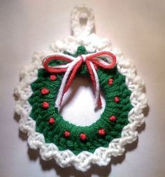 a crocheted christmas ornament hanging on a wall