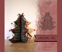 two christmas trees sitting next to each other on a wooden table with the words pop pattern christmas tree