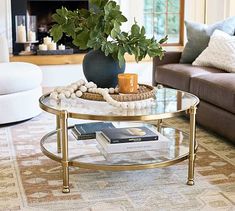 a living room with two couches and a coffee table in front of a fireplace