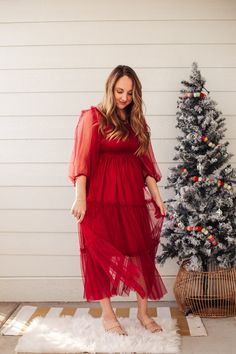 This stunning red dress is a SHOWSTOPPER! It has a lovely, bold color, mesh tiered maxi with long sleeves and smocked top, and 3/4 dress. The mesh material is not itchy and is very comfortable to wear. Model is wearing a size large. Red Holiday Dress, Roses Are Red, Smocked Top, Women Encouragement, Bold Color, Mesh Material, Holiday Dresses, Christmas Photos, New Trends