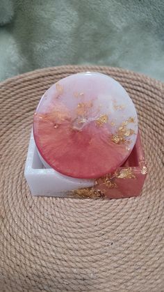 a piece of pink and gold marble sitting on top of a table