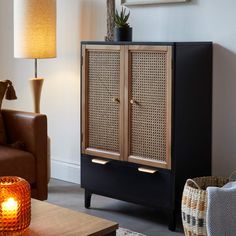 a living room with a brown couch and a cabinet in it's centerpiece