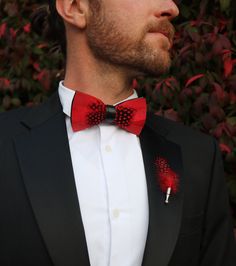 The Jaxon Feather bow tie is a classic red and black tie that will keep it sharp and your look formally fresh. It is a classic, understated, and unique groom's tie. Perfect for weddings and special events. An absolute must-have bow tie to add to your collection. This sleek red tie also comes in children's sizes so your groomsmen and ring bearer bow ties can match! Every Feather Bow Ties Comes with: Beautiful, Hand-Crafted, High Quality Feather Bow Tie, with an adjustable strap that can fit up to Red Bow Tie As Gift, Elegant Red Suit And Tie Accessories For Black-tie Events, Dapper Red Bow Tie For Party, Dapper Bow Tie For Formal Occasions, Classic Red Bow Tie For Wedding, Red Bow Suit And Tie Accessories For Party, Formal Bow Tie With Red Bow, Adjustable Red Suit And Tie Accessories For Wedding, Party Red Bow Suit And Tie Accessories