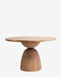 a wooden table with a circular base on it's top and one leg in the shape of a ball