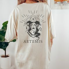 the back of a woman's t - shirt that reads, artemus