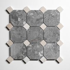 a white and grey marble tile with hexagonal shapes