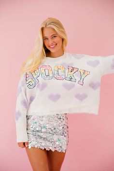 Get spooky and stylish with our SPOOKY HEART SWEATER! This cute and classic sweater features pastel purple hearts and colorful ghost lettering, perfect for adding a touch of Halloween to your wardrobe. Don't miss out on this must-have statement piece! All orders are currently shipping within 14 business days. To receive item quicker, expedited shipping is available at checkout. **ALL HALLOWEEN ORDERS MUST BE PLACED WITH EXPEDITED SHIPPING TO GUARANTEE DELIVERY BY OCT. 31 IF PLACED AFTER OCT. 15* Purple Letter Print Sweater For Fall, Playful Letter Print Sweater For Fall, Cute Heart Graphic Sweater For Fall, Ghost Lettering, Colorful Ghost, Purple Hearts, Neon Aesthetic, Heart Sweater, Classic Sweater