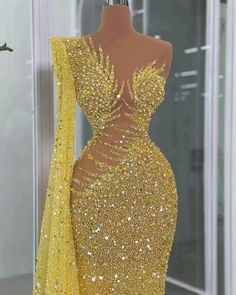 a mannequin with gold sequins on it's body and long sleeves