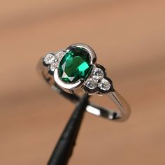 It is a lab emerald ring. The main stone is 6 mm*8 mm oval cut.weight about 1.13 carats. The basic metal is sterling silver and plated with rhodium. To change the metal to a solid gold (white/rose) or platinum is also available, please ask for a quotation if you want. You can also go to my shop Home for more elegant rings: https://www.etsy.com/shop/godjewelry?ref=hdr_shop_menu Emerald is the May birthstone More emerald rings: https://www.etsy.com/shop/godjewelry?section_id=20709240 Customization Emerald Ring Wedding, Emerald Solitaire Engagement Ring, Emerald Engagement Ring Green, Emerald Ring Engagement Diamond, Emerald Wedding Rings, Green Emerald Ring, May Birthstone, Emerald Engagement, Ring Oval