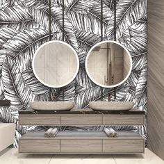 a bathroom with two sinks and mirrors in front of a palm leaf wallpaper design