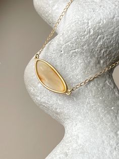 Embrace the captivating allure of the Baltic sea with this chic, elliptical amber pendant. Each piece showcases a pristine slice of natural Baltic amber, renowned for its warmth and depth, encased in a sophisticated gold-plated sterling silver frame. This pendant is the essence of elegance, designed to add a touch of timeless sophistication to any outfit. Its unique organic patterns ensure that no two pendants are alike, offering you an exclusive piece of the earth's beauty. Sterling silver, amber, gold plated Chain length 15 - 16.5" Stone size 1,06" Weight 0,22 oz Soft Autumn Jewelry Accessories, Soft Autumn Jewelry, Organic Patterns, Organic Pattern, Soft Autumn, Amber Pendant, Fall Jewelry, Amber Jewelry, Baltic Sea