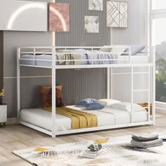 a white bunk bed sitting next to a window in a room with wooden flooring