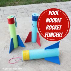 some paper rockets are on the ground with a sign that says pool noodle rocket finger