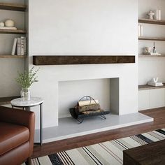 a living room with a fire place in the center and shelves on the other side