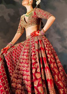 Indian Bridal Dress in Red Lehenga and Choli Style is a traditional masterpiece that will give you a trendy as well as festive bridal look. The beautiful cutwork on this Lehenga Choli and premium organza fabric make this Bridal Lehenga Choli your foremost priority to have a gorgeous look on the wedding. Lehenga Choli: The choli with V-neckline has an alluring red shade and is beautifully emblazoned with goldwork and threads. Dabka, stones, beads, tilla, and sequin work make this beautiful choli a perfect choice to pair with Bridal Lehenga. The intricate floral designs and shimmering details give a glamorous finishing to the red choli. Bridal Lehenga: This Bridal Lehenga has a huge flare and is fully embellished with goldwork and shimmering embellishments. The Red Lehenga comes in pure orga Choli Style, Wedding Lehenga Choli, Lehnga Dress, Red Lehenga, Indian Bridal Dress, Indian Blouse, Bridal Lehenga Choli, Designer Dresses Casual, Indian Clothes