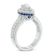 a white gold ring with blue and white diamonds on the side, set in 18k white gold