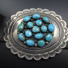 "VINTAGE NAVAJO BELT DESCRIPTION: This spectacular belt features 7 conchos and a buckle replete with clustered cabs of natural high blue Morenci turquoise. Over-sized hand-stamped conchos are dramatic vehicles for the brilliant gemstones. Circa 1970s, this belt will be a cherished addition to your collection of fine vintage Native American jewelry. MEASUREMENTS: 44.5\" long x 1 3/8\" wide Belt is currently punched to fit from 39\" to 41\" Buckle measures 3 3/4\" x 3\" Conchos measure 3 3/4\" x 3 Vintage Turquoise Belt With Concho, Blue Concho Western Belt Buckles, Western Style Blue Concho Belt Buckles, Navajo Belt, Jewelry Measurements, Morenci Turquoise, Vintage Native American Jewelry, Natural High, Vintage Navajo