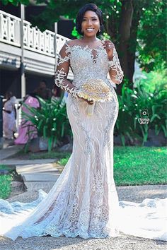 a woman in a white dress is standing outside