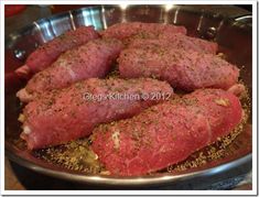 raw meat in a frying pan with seasonings on the top and bottom side