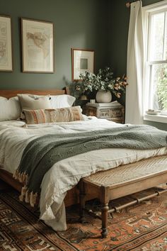 a bedroom with green walls and white linens on the bed, along with an antique rug