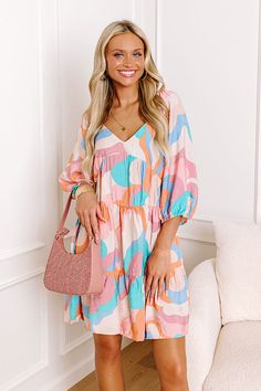 - We are obsessed with this vibrant dress! - Unlined material with a colorful print - A v-cut neckline - Short sleeves with elastic shoulders and elastic cuffs - Hidden side pockets - A square cut back with a smocked detail - A flowy yet flattering silhouette that ends in a flirty mini dress length hemline Measurements S : Bust 32", Hip 42", Length 28.5", Sleeve Length 16.5", Waist 34". M : Bust 34", Hip 44", Length 28.5", Sleeve Length 17.5", Waist 36". L : Bust 36", Hip 46", Length 29", Sleeve Kids Athleisure, Palm Beach Style, Fall Style Guide, Vibrant Dress, Babydoll Mini Dress, Impressions Online Boutique, Swimwear Dress, Little White Dresses, Square Cut