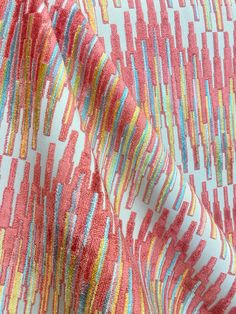 the fabric is very colorful and has many lines on it, as well as stripes