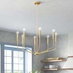 a modern chandelier hanging from the ceiling in a dining room with blue walls