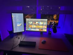 a desk with two monitors and a keyboard