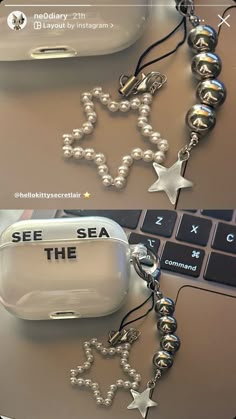 there is a cell phone with a chain attached to it that says see the sea