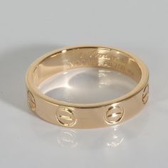 Cartier Love Band in 18k Yellow Gold  PRIMARY DETAILS  SKU: 140024  Listing Title: Cartier Love Band in 18k Yellow Gold  Condition Description: Cartier's Love collection is the epitome of iconic, from the recognizable designs to the history behind the line-up. The collection started in 1969 with the bangle bracelet, which is engraved with a circular motif throughout to mimic the look of the bracelet's signature screw-lock mechanism.     Retails for 1250 USD. In excellent condition and recently polished. Ring size is 48. Comes with Box;  Brand: Cartier  Collection/Series: Love  Metal Type: Yellow Gold  Metal Purity: 18k  Ring Size: 48  Pre-Owned Jewelry Condition: Excellent  SIDE STONE INFORMATION  Original Box?: Yes  Original Papers?: No  This item has been used and may have some minor fla Luxury Cartier Diamond Ring, Designer Polished 14k Gold Rings, Designer 14k Gold Rings With Polished Finish, Cartier 14k Gold Jewelry With Vvs Clarity, Luxury Rose Gold Rings Stamped 14k, Luxury Gold Stackable Rings With Tension Setting, Luxury Stackable Round Band Diamond Ring, Luxury Stackable Diamond Ring With Round Band, Designer 14k Gold Rings With Brilliant Cut