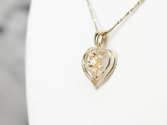 This seed pearl heart pendant is utterly sweet! A polished, openwork design lets lots of light into the piece, allowing the gold to shine brightly. Tiny seed pearls and a sparkling diamond add elegance and femininity, making this piece a lovely choice for an anniversary gift or bridal pendant. This pendant does not come with the chain shown. Please feel free to contact us, we will help you find the perfect chain for your style and budget! Metal: 14K Yellow Gold Gem: Diamond .03 Carats Gem Measur Fine Jewelry Heart Pendant Necklace For Wedding, Wedding Heart Pendant Necklace In Fine Jewelry Style, Wedding Fine Jewelry Heart Pendant Necklace, Fine Jewelry Yellow Gold Heart Necklace For Wedding, Fine Jewelry Heart Necklace With Birthstone For Wedding, Wedding Heart Necklace With Birthstone In Fine Jewelry Style, Wedding Fine Jewelry Heart Necklace With Birthstone, Wedding Heart Necklace With Birthstone, Fine Jewelry Heart Necklace With Diamond Cut For Wedding