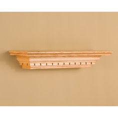 a wooden shelf on the wall with holes in it