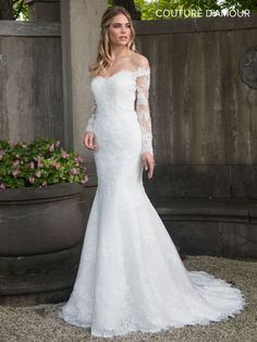 a woman in a white wedding dress posing for the camera