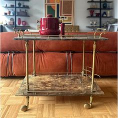 a living room with a couch and a coffee table on wheels in front of it