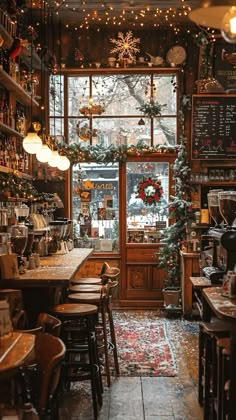 the inside of a restaurant with christmas decorations on the windows and tables in front of it