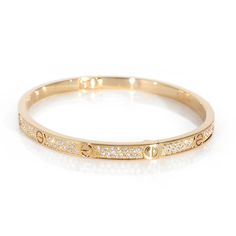 This is part of Chairish’s Fine Jewelry assortment.  Cartier Love Bracelet, Small Model, Paved 18K Yellow Gold 0.95 CTW   PRIMARY DETAILS   SKU: 137659   Listing Title: Cartier Love Bracelet, Small Model, Paved 18K Yellow Gold 0.95 CTW   Condition Description: Cartier's Love collection is the epitome of iconic, from the recognizable designs to the history behind the line-up. The collection started in 1969 with the bangle bracelet, which is engraved with a circular motif throughout to mimic the look of the bracelet's signature screw-lock mechanism.       Retails for 27300 USD. In excellent condition and recently polished. Comes with Box;Pouch;Original Receipt;   Brand: Cartier   Collection/Series: Love   Metal Type: Yellow Gold   Metal Purity: 18K   Pre-Owned Jewelry Condition: Excellent Cartier Single-cut Diamond Bracelets, Cartier Gold Diamond Bracelets, Cartier Round Bracelet With Single Cut Diamonds, Cartier Bracelets With Single Cut Diamonds, Luxury Engraved Round Bracelets, Cartier Gold Jubilee Bracelet For Wedding, Cartier Fine Jewelry Bracelet With Diamond Accents, Gold Cartier Diamond Bracelet With 17 Jewels, Cartier Bangle With Single Cut Diamonds