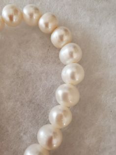 "Edison Pearls White 10mm Semi Round - Large Hole 8 inch strands, 28 Grams per strand, 21-22 beads per strand, I have several strands available! I am selling my entire inventory. ADDITIONAL INFORMATION Edison Pearls - What Are They?: Edison Pearls are made from freshwater mollusks but are nucleated (created) like saltwater pearls, with a mother of pearl bead inserted in the gonad of the mollusk. Find out more about Edison Pearls on our Blog. What is it: Pearls are produced within the soft tissue Pearl White Single Strand Beaded Bracelet, Pearl White Single Strand Bracelet With Round Beads, Pearl White Single Strand Beaded Bracelets, Single Strand Round Beads Pearl Bracelet, Pearl White Beaded Bracelet, Hand-strung Classic Round Pearl Bracelet, Classic Hand-strung Round Pearl Bracelet, Single Strand Pearl Beaded Bracelets, Pearl Bracelet With Round Beads